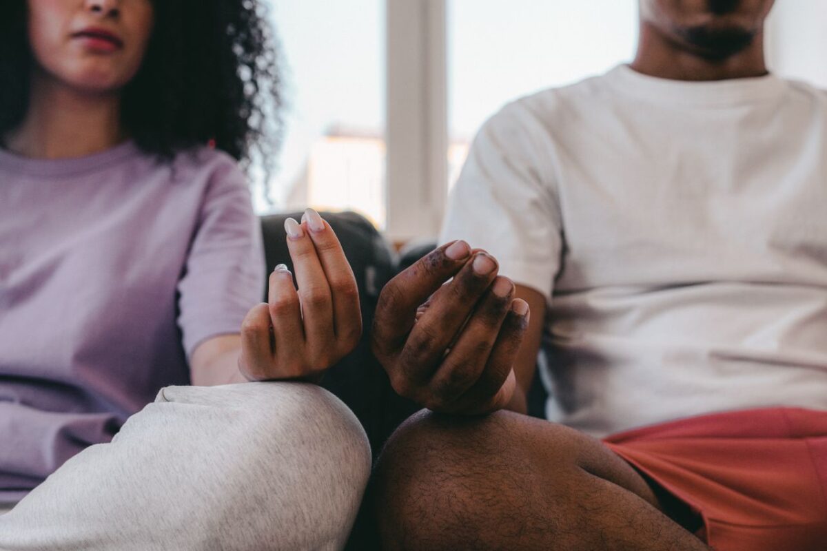 Couple practicing meditation at home, focusing on mindfulness and relaxation.